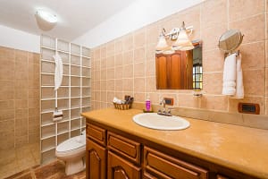 Elegant bathroom with Spanish colonial details and modern fixtures at Casa Margarita, Playa Flamingo