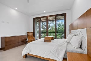 Elegant bedroom with private balcony and modern tropical design at Tamarindo Park #51 in Playa Tamarindo.
