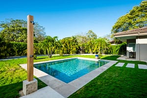 Luxurious outdoor pool at Casa Kenya, surrounded by tropical landscaping and modern architecture in Hacienda Pinilla, Costa Rica.