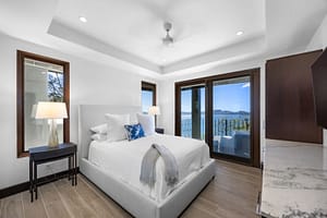 Elegant ocean-view bedroom with floor-to-ceiling windows, a plush bed, and direct access to a private veranda at 360 Splendor del Pacifico Flamingo.