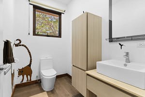 Modern ensuite bathroom at Casa Artistica, featuring elegant finishes, a spacious vanity, and a walk-in shower for a spa-like experience.