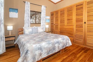 Spacious and elegantly designed bedrooms with panoramic views, queen-size beds, and modern furnishings in a luxury mountain retreat near Arenal Volcano, Costa Rica.
