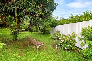Lush tropical garden with native flora, vibrant greenery, and scenic pathways surrounding a luxury retreat near Arenal Volcano, Costa Rica.
