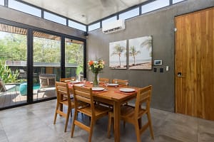Open-concept dining area at Villa Aquarena with modern furnishings and garden views