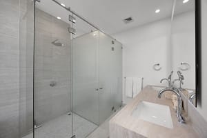 Luxurious bathroom at Solaris Acacia 1A in Reserva Conchal, featuring a spa-like walk-in shower, double vanity, and elegant modern finishes.