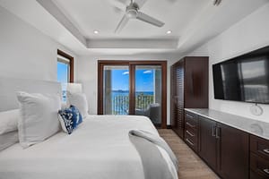 Elegant ocean-view bedroom with floor-to-ceiling windows, a plush bed, and direct access to a private veranda at 360 Splendor del Pacifico Flamingo.