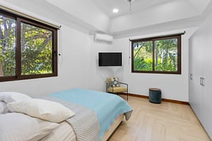 Spacious and stylish bedroom at Casa Artistica, featuring custom-painted walls, elegant furnishings, and an ensuite bathroom for ultimate comfort.