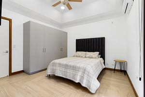 Spacious and stylish bedroom at Casa Artistica, featuring custom-painted walls, elegant furnishings, and an ensuite bathroom for ultimate comfort.