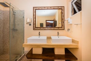 Modern ensuite bathroom with sleek fixtures in the second bedroom of Naxos 8 condominium.