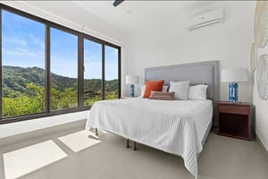 Elegant bedroom at Villa Oceana with ocean views, natural light, and modern tropical design.