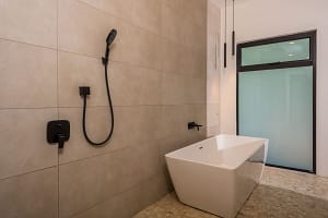 Luxury freestanding bathtub with garden views in master bathroom at Llama del Bosque 27, Reserva Conchal