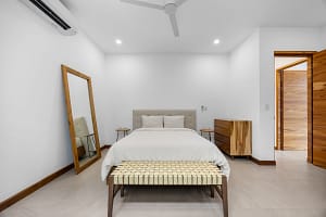 Elegant bedroom with private balcony and modern tropical design at Tamarindo Park #51 in Playa Tamarindo.