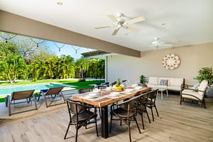 Outdoor dining area on the terrace at Casa Kenya, featuring a stylish table, comfortable seating, and stunning tropical views in Hacienda Pinilla, Costa Rica.