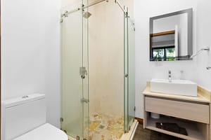 Modern ensuite bathroom at Casa Artistica, featuring elegant finishes, a spacious vanity, and a walk-in shower for a spa-like experience.