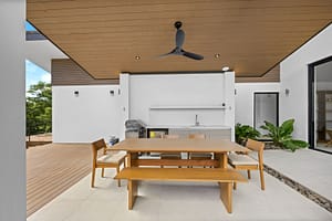 Outdoor kitchen and BBQ area at Casa Aguasalada, featuring a built-in grill, spacious countertops, and a covered dining space with golf course views.