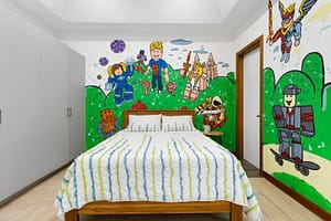 Spacious and stylish bedroom at Casa Artistica, featuring custom-painted walls, elegant furnishings, and an ensuite bathroom for ultimate comfort.