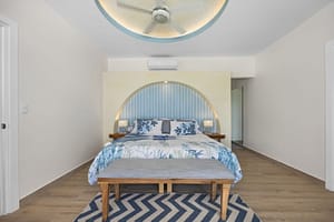 Luxurious master bedroom at Casa Camari with themed design, elegant furnishings, and breathtaking ocean views.