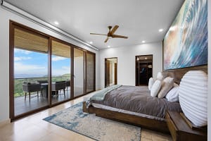 Spacious ocean-view bedroom with custom woodwork and luxurious finishes at Casa Seahorse in Mar Vista, Playa Flamingo.