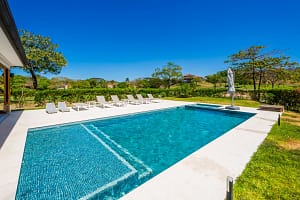 Luxury private swimming pool surrounded by tropical gardens at Llama del Bosque 27 in Reserva Conchal, Costa Rica