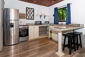 Modern, fully equipped kitchen with high-end appliances, sleek countertops, and a spacious layout in a luxury retreat near Arenal Volcano, Costa Rica.