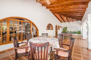 Spacious wraparound terrace with tropical garden and pool views at Casa Margarita, Playa Flamingo