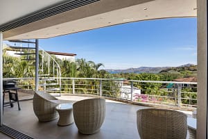Private balcony with panoramic ocean and mountain views at Casa Nalifos, Playa Flamingo, Costa Rica."