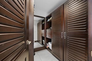 Spacious walk-in closet with custom shelving, ample storage, and elegant lighting at 360 Splendor del Pacifico Flamingo.