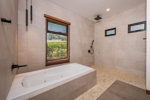 Luxury freestanding bathtub with garden views in master bathroom at Llama del Bosque 27, Reserva Conchal