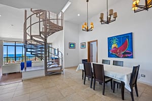 Elegant indoor dining area with natural light and ocean-view terrace at Casa Veranera