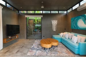 Stylish open-concept living room at Villa Aquarena with modern décor and seamless indoor-outdoor flow.