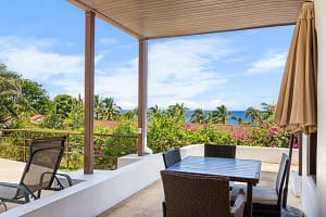 Ocean-view balcony with outdoor seating at Casa Veranera in Playa Flamingo