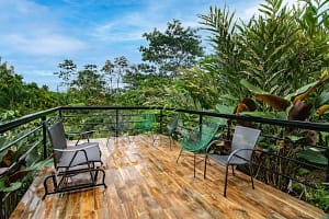 Spacious private balcony with breathtaking views of Arenal Volcano and the lush tropical rainforest, perfect for relaxation and outdoor dining. Title: "Private Balcony with Stunning Arenal Volcano Views – Luxury Retreat in Costa Rica" Caption: "Unwind on your private balcony with panoramic views of Arenal Volcano and the surrounding tropical rainforest. A perfect spot for morning coffee, sunset cocktails, and nature watching." Description: "This luxury mountain retreat features a spacious private balcony designed to maximize your connection with nature. Enjoy breathtaking views of Arenal Volcano, lush rainforests, and Costa Rica’s exotic wildlife from the comfort of your home. Whether you’re sipping your morning coffee, dining al fresco, or relaxing under the stars, the balcony provides a serene and picturesque setting. Perfect for nature lovers, this outdoor space enhances the beauty and tranquility of your stay.