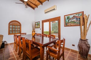 Elegant dining area with teak furniture and ocean breeze at Casa Margarita, Playa Flamingo