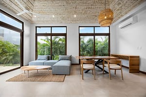 Bright open-concept living and dining area with tropical views at Tamarindo Park #51 in Playa Tamarindo.