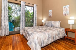 Spacious and elegantly designed bedrooms with panoramic views, queen-size beds, and modern furnishings in a luxury mountain retreat near Arenal Volcano, Costa Rica.