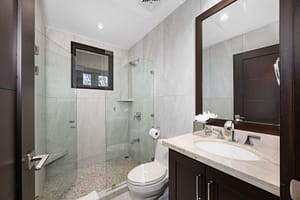Spa-like bathroom with a glass-enclosed shower, elegant vanity, and ocean views at 360 Splendor del Pacifico Flamingo.