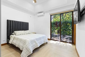 Spacious and stylish bedroom at Casa Artistica, featuring custom-painted walls, elegant furnishings, and an ensuite bathroom for ultimate comfort.