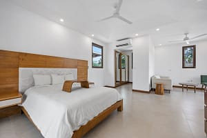 Elegant bedroom with private balcony and modern tropical design at Tamarindo Park #51 in Playa Tamarindo.