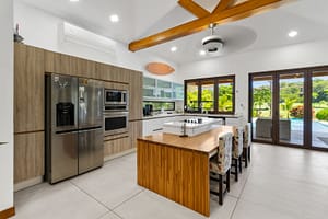 Modern open-concept kitchen at Casa Artistica, featuring high-end appliances, ample counter space, and a stylish design for culinary enthusiasts.