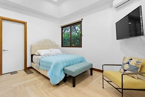 Spacious and stylish bedroom at Casa Artistica, featuring custom-painted walls, elegant furnishings, and an ensuite bathroom for ultimate comfort.