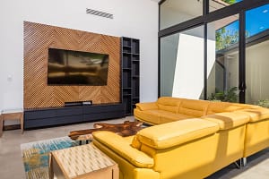 Bright modern living room with high ceilings, open layout, and golf course views at Llama del Bosque 27 in Reserva Conchal
