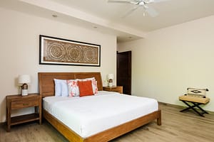 Elegant and spacious bedroom at Casa Kenya, featuring luxurious bedding, modern decor, and serene tropical views in Hacienda Pinilla, Costa Rica.