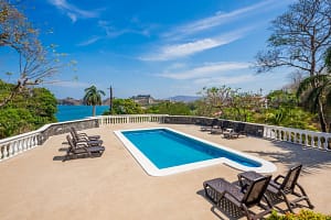 Expansive private pool surrounded by tropical gardens at Casa Margarita, Playa Flamingo
