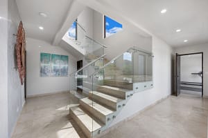Elegant staircase with custom wood and stone accents at Casa Seahorse in Mar Vista, Playa Flamingo.