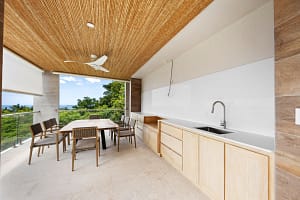 Spacious outdoor terrace at Casa Manta Ray with ocean views, dining area, and infinity poolside lounge.