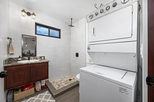Modern bathroom in the guest house with sleek fixtures, spacious shower, and contemporary design.