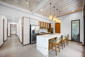 Modern kitchen with high-end appliances and island seating at Tamarindo Park #51 in Playa Tamarindo.