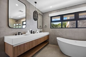 Modern bathroom in Casa Aguasalada, featuring a sleek vanity, walk-in shower, and elegant teak accents.
