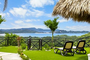 Casa Camari’s beautifully landscaped gardens featuring lush tropical plants, stone pathways, and serene outdoor spaces.