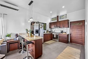 Modern open-concept kitchen in the guest house with sleek countertops, ample storage, and natural light.